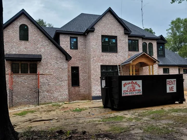 Bubba Dumps roll-off dumpster rentals outside a new home being built in Dothan, Alabama